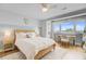 Light bedroom features a cozy bed, ceiling fan, and a view of the outdoors at 5 Mariners Cay Dr, Folly Beach, SC 29439
