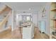 Cozy dining area with wooden table, staircase, and view into kitchen area for seamless living space at 5 Mariners Cay Dr, Folly Beach, SC 29439