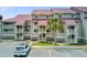 Exterior view of the condo building showcasing the multiple units, balconies and gray paint scheme at 5 Mariners Cay Dr, Folly Beach, SC 29439