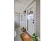A cozy front porch with a glass front door, gray siding, and decorative plants and welcome mat at 5 Mariners Cay Dr, Folly Beach, SC 29439