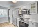 Well-lit kitchen featuring stainless steel appliances, white cabinets, and modern fixtures for a sleek cooking experience at 5 Mariners Cay Dr, Folly Beach, SC 29439
