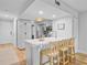 Bright kitchen features a breakfast bar with seating, modern appliances, and stylish white cabinetry at 5 Mariners Cay Dr, Folly Beach, SC 29439