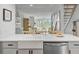 Bright kitchen overlooking living area, featuring stainless steel appliances and contemporary finishes at 5 Mariners Cay Dr, Folly Beach, SC 29439