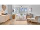 Bright living room features light hardwood floors and plush seating near large windows offering beautiful waterfront views at 5 Mariners Cay Dr, Folly Beach, SC 29439