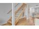 Modern staircase with wooden treads, metal railings, and beachy accents at 5 Mariners Cay Dr, Folly Beach, SC 29439
