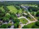 Expansive aerial view of the community featuring a golf course, clubhouse, and lush landscaping at 5105 St George Ln, Hollywood, SC 29449