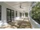 Expansive outdoor balcony with white railings and ceiling fans, offering a serene outdoor living space at 5105 St George Ln, Hollywood, SC 29449