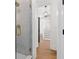 Bathroom boasting tiled shower with glass doors and access to an open hallway and staircase at 5105 St George Ln, Hollywood, SC 29449