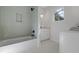 Well-lit bathroom with a shower-tub combo featuring blue tiles and a vanity with marble countertops at 5105 St George Ln, Hollywood, SC 29449
