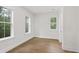 Bright bedroom with hardwood floors, three windows, and white trim throughout at 5105 St George Ln, Hollywood, SC 29449