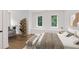 Serene bedroom features hardwood floors, stylish shelving, and two large windows offering natural light at 5105 St George Ln, Hollywood, SC 29449