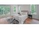 Bright bedroom features a large bed, wood floors, and access to an outdoor balcony through sliding glass doors at 5105 St George Ln, Hollywood, SC 29449