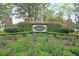 Community entrance sign, showcasing lush landscaping and brick masonry at 5105 St George Ln, Hollywood, SC 29449