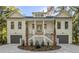Traditional home exterior with double garages, a welcoming staircase, and tasteful landscaping at 5105 St George Ln, Hollywood, SC 29449