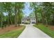Stunning property featuring a traditional home nestled among trees with a long driveway and lush landscaping at 5105 St George Ln, Hollywood, SC 29449
