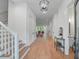 Hallway featuring hardwood floors and crisp white trim to an open floor plan with comfortable chairs at 5105 St George Ln, Hollywood, SC 29449