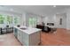 Kitchen with center island opens to the living room with fireplace and outdoor deck at 5105 St George Ln, Hollywood, SC 29449