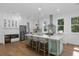 Bright kitchen features a large island, stainless steel appliances, and hardwood flooring at 5105 St George Ln, Hollywood, SC 29449