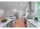 Bright kitchen with white cabinets, stainless steel appliances, island, and hardwood floors at 5105 St George Ln, Hollywood, SC 29449