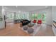 Spacious living room with open floor plan, modern fireplace and hardwood floors with backyard views at 5105 St George Ln, Hollywood, SC 29449