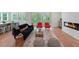 Spacious living room featuring a modern fireplace, hardwood floors and access to an outdoor deck at 5105 St George Ln, Hollywood, SC 29449