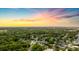 Scenic aerial shot of a neighborhood surrounded by green forest during a colorful sunset at 514 Shady Maple St, Moncks Corner, SC 29461