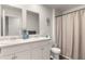 Bright bathroom with double sinks, white cabinetry, and neutral tones creates a clean, functional space at 514 Shady Maple St, Moncks Corner, SC 29461