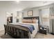 Cozy bedroom features a dark wood frame bed, soft, layered bedding, and large windows for a bright, airy feel at 514 Shady Maple St, Moncks Corner, SC 29461