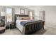 Serene bedroom with dark wood furniture, layered bedding, and abundant natural light creates a relaxing retreat at 514 Shady Maple St, Moncks Corner, SC 29461