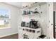 Coffee bar with a white cabinet, multiple coffee machines, and open shelving at 514 Shady Maple St, Moncks Corner, SC 29461