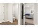 Hallway view showcasing a nearby bathroom with a toilet and vanity and connecting to a bedroom at 514 Shady Maple St, Moncks Corner, SC 29461