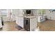 Open-concept kitchen and living area with modern appliances, a central island, and stylish decor at 514 Shady Maple St, Moncks Corner, SC 29461