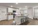 Bright kitchen with stainless steel appliances, a central island with seating, and modern light fixtures at 514 Shady Maple St, Moncks Corner, SC 29461