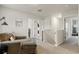 Upstairs landing with a comfortable chaise and multiple bedroom entry doors at 514 Shady Maple St, Moncks Corner, SC 29461