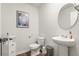 Neat powder room with pedestal sink, toilet, and decorative accents at 514 Shady Maple St, Moncks Corner, SC 29461
