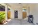 Covered back patio with brick flooring, convenient access door, and a gas grill ready for outdoor cooking at 5155 Monterey St, North Charleston, SC 29405