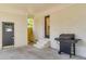 Covered back patio with brick flooring, convenient access door, and gas grill at 5155 Monterey St, North Charleston, SC 29405