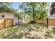 Large, fenced backyard with manicured lawn and ample shade from mature trees at 5155 Monterey St, North Charleston, SC 29405