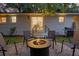 Inviting backyard with gravel firepit, seating, and overhead string lights, perfect for entertaining at 5155 Monterey St, North Charleston, SC 29405