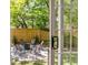 Inviting backyard featuring a cozy fire pit area with chairs, wood fence, and lush greenery, perfect for outdoor relaxation at 5155 Monterey St, North Charleston, SC 29405