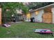 Spacious backyard features a fire pit, grill, lawn games, and a well-maintained lawn with mature trees at 5155 Monterey St, North Charleston, SC 29405