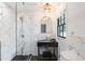 Beautifully remodeled bathroom showcases modern fixtures, textured tile, and glass shower enclosure at 5155 Monterey St, North Charleston, SC 29405