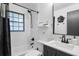 Modern bathroom featuring a tub with black fixtures, subway tile surround, and updated sink with a large mirror at 5155 Monterey St, North Charleston, SC 29405