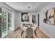 Bright dining room with a modern light fixture and sliding doors to outdoor area at 5155 Monterey St, North Charleston, SC 29405