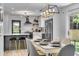 Stylish eat-in kitchen with stainless steel appliances, pendant lighting, and gray and white cabinetry at 5155 Monterey St, North Charleston, SC 29405