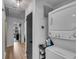 Bright laundry room featuring a stacked washer and dryer and storage on a metal shelving rack at 5155 Monterey St, North Charleston, SC 29405