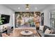 Modern living room featuring a large mural of Charleston, leather sofa and decor at 5155 Monterey St, North Charleston, SC 29405