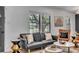 Cozy living room with a modern sofa, a black accent wall, and two windows at 5155 Monterey St, North Charleston, SC 29405