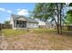 Home's backyard featuring a screened-in porch, wooden fence, and mature shade trees at 5332 Copley Cir, Summerville, SC 29485