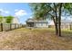 Home's backyard featuring a screened-in porch, wooden fence, and mature shade trees at 5332 Copley Cir, Summerville, SC 29485
